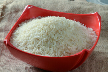 raw Basmati Rice on red bowl with even lighting 