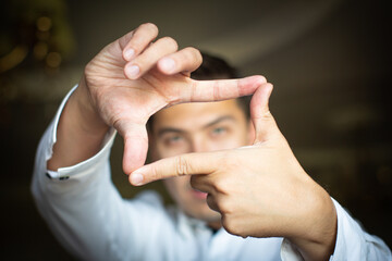 a man makes a square with his hands