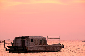A vintage boat parked at Asker coast during sunrise, Bahrain