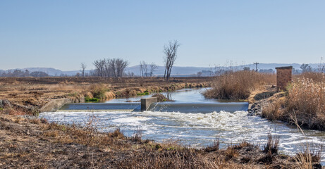 Fototapeta na wymiar The Klip River runs through a dry winter Gauteng Highveld landscape in South Africa image in horizontal format
