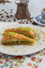 Turkish coffee and Traditional Turkish dessert baklava in plate on wooden table