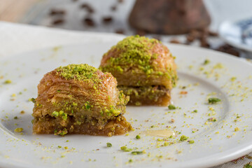 Turkish coffee and Traditional Turkish dessert in plate on wooden table