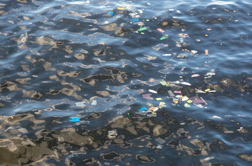 Trash in sea water. Plastic bags in ocean. Ecological problem. Urban seaside pollution. Human influence to wild life