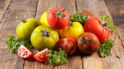 assorted differents variety of tomatoes on wood background