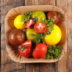 assorted differents variety of tomatoes on wood background
