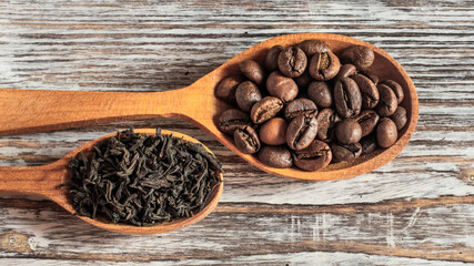 Coffee beans and tea in wooden spoons