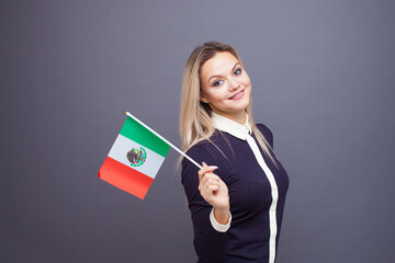 Immigration and the study of foreign languages, concept. A young smiling woman with a Mexico flag...