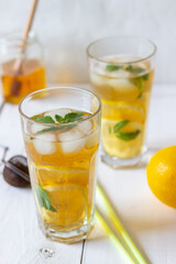 Fototapeta na wymiar Cold tea with lemon and mint. A summer drink. Healthy eating. Vegetarian food. Diet.