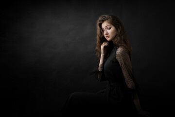 Obraz na płótnie Canvas Studio portrait of a beautiful girl on a black background