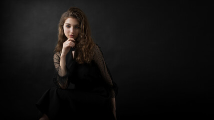 Studio portrait of a beautiful girl on a black background