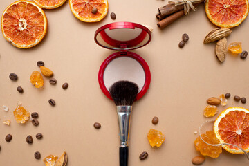 Obraz na płótnie Canvas Cosmetics for natural makeup, powder, fluffy makeup brush on top.