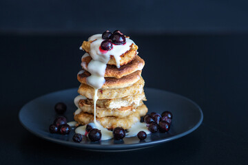 Oatmeal pancakes with berries and sweet sauce,