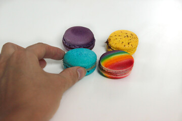 Girl takes dessert with her hand - French macaroons