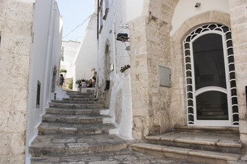 Old town of Ostuni during a sunny day, the white village. It is a turistic destination in Puglia ( apulia) in the summer. The city is in white stone bricks and is very old ( medieval time).