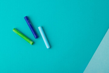 pastel crayons on blue background. top view. copy space. school concept