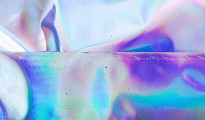 high res full frame macro photo of abstract pastel iridescent holographic foil background with...