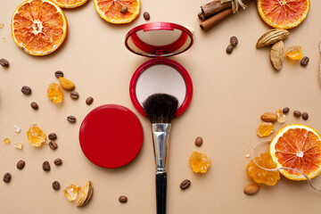 Fototapeta na wymiar Cosmetics for natural makeup, powder, fluffy makeup brush on top.