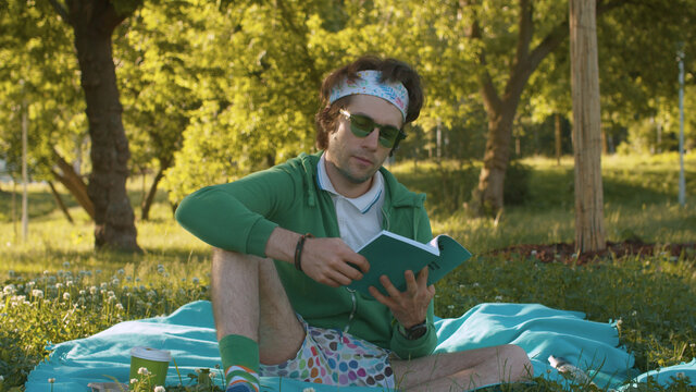 Humorous portrait of a funny freak man reading a book