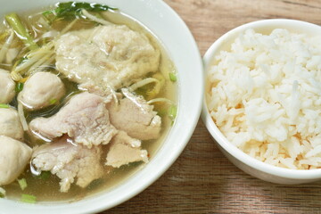 boiled soft slice pork and ball in clear soup on bowl eat with plain rice