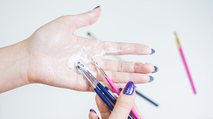 Hygienic care of makeup artist tools, women's hands wash the brush from cosmetics, soap and cleaning products,