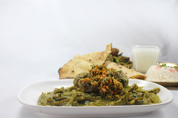 Cluster Beans Curry-Gwar ki Sabzi served with rice roti and Papad.selective focus.