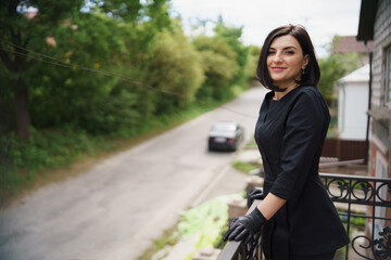 beautiful girl beautician in a black suit, gloves, breathes fresh air.