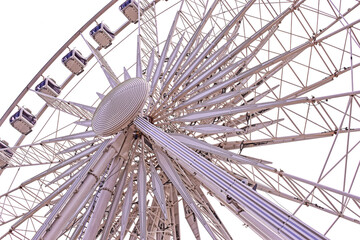 White ferris wheel underside view on clean sky