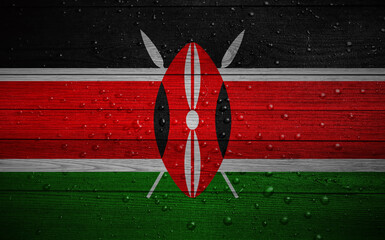 Kenya flag on wooden boards with water drops