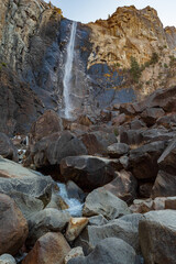 A view of the winter Bridalveil Fall and the huge river rocks of Yosemite Park, California.