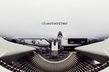 The word ghost writer typed on the paper with a vintage typewriter - obrazy, fototapety, plakaty