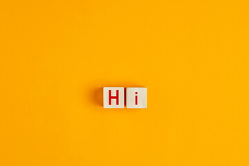 The word hi on wooden blocks. Greeting and welcoming in hospitality business concept.