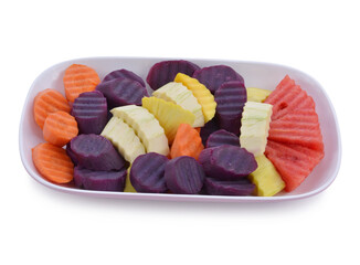 healthy food. fresh fruit salad on a white plate. vegan food on the yellow background.