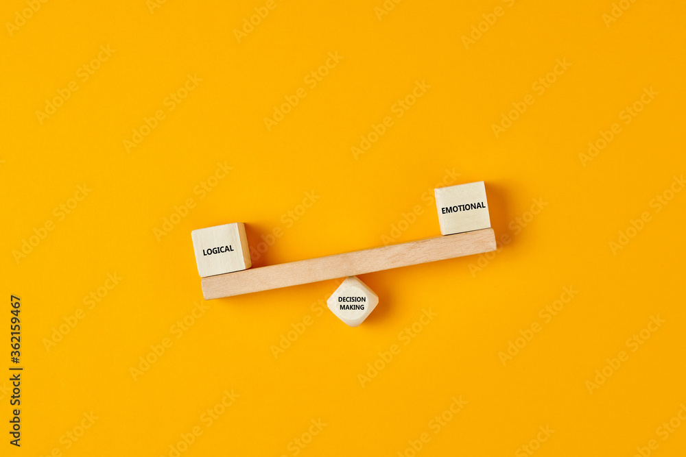 Poster using logic rather than emotions in business decision making. wooden blocks designed as a seesaw wit