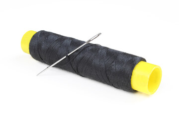 Needle and black thread isolated on white background. 