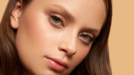 Fototapeta premium Closeup Of Beautiful Young Woman Face With Natural Makeup. Blanc space 