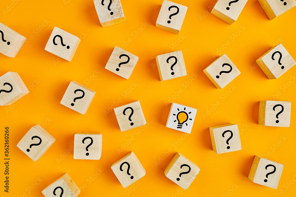 Aufkleber concept of to find a creative idea or problem solving. question mark and light bulb icons on wooden 