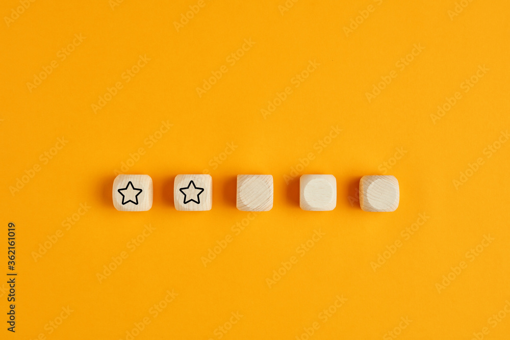 Poster wooden cubes with two stars out of five. concept of poor service rating and evaluation.