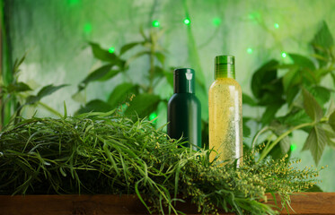 Bottle with tarragon oil. Fresh green tarragon and essential oil