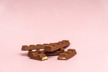 
milk chocolate with a filling on a pink background
