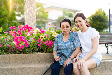 Portrait of elder Asian woman age around 85 - 90 years old and her granddaughter relaxing at the...