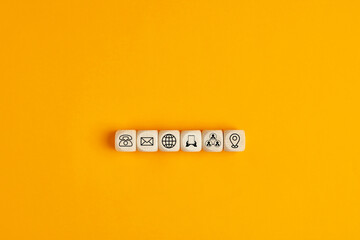 Online business communications concept with icons on wooden cubes