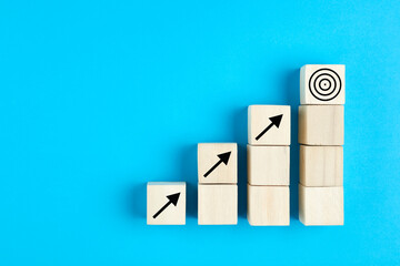 Business or economic growth concept with arrow icons on wooden cubes