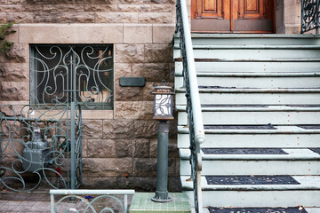 Stone facades and the entrance stairs of row houses in Montreal, Canada. © Cagkan
