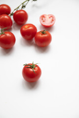 Food composition of many fresh ripe red tomatoes on white background