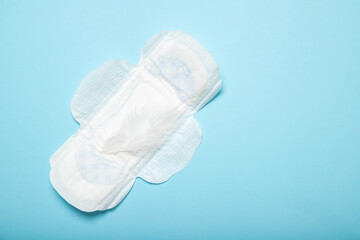 Feminine pads on a blue background. Menstruation. Gynecology. Women Health. Place for text