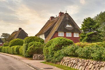 Country house, romantic thatched cottage. Fairytale landscape on the island of Sylt, North Frisian...