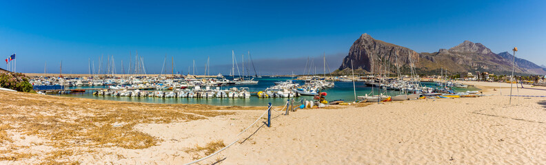 : A panorama from the beach of San Vito lo Capo, Sicily with impressive mountain backdrop in summer
