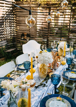 Decorated table in a rustic style, outdoors at a backyard garden party.