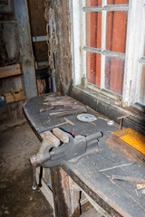 Old workbench with a vice in a workshop