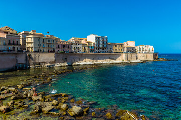 Fototapeta premium A view along the shoreline and embankment of Ortygia island in Syracuse, Sicily in summer